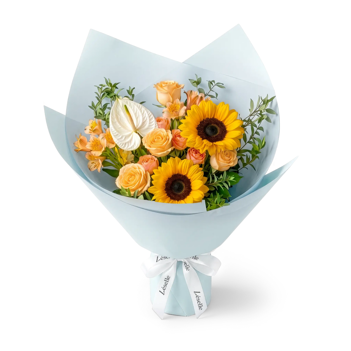 A wrapped flower bouquet featuring black-heart sunflowers, champagne roses, a white anthurium, and green foliage, wrapped in a pale blue paper sleeve with a white ribbon, on a transparent background.