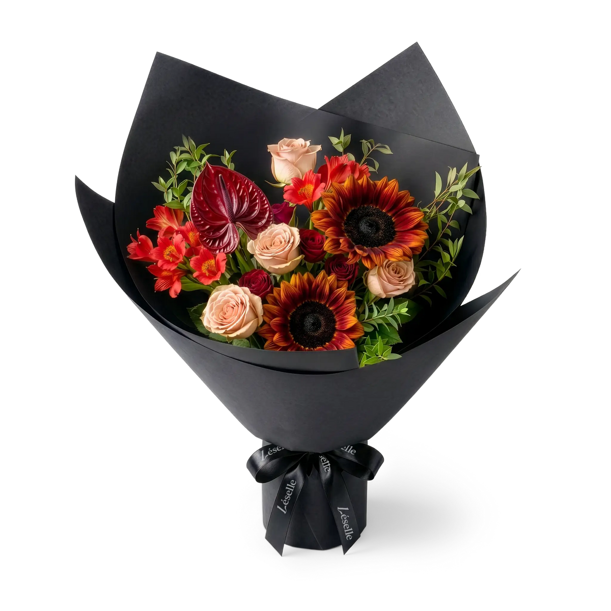A wrapped flower bouquet featuring burgundy sunflowers, cappuccino roses, a dark red anthurium, and green foliage, wrapped in a black paper sleeve with a black ribbon, on a transparent background.